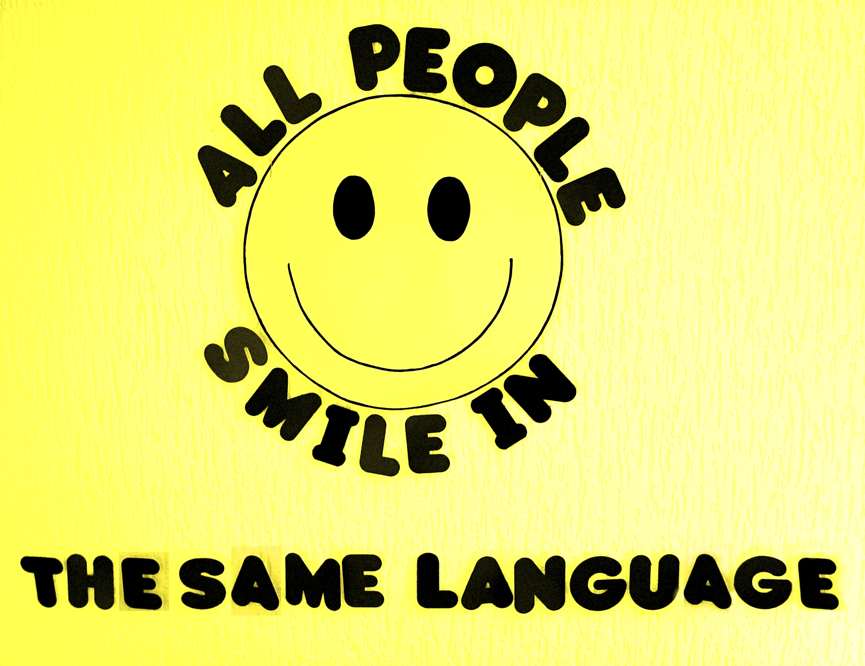 Grafik mit Text "All people smile in the same language"